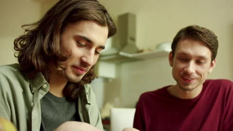 Two lovely men are cooking together and talking Stock Footage 160170989