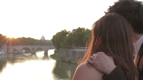 Two lovers admire the sunset, with the background of St Peter - sunshine Stock Footage 28499553