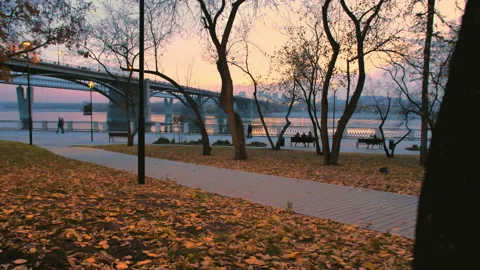 Two lovers are walking along the embankment in the evening against the backdrop Stock Footage 136201245