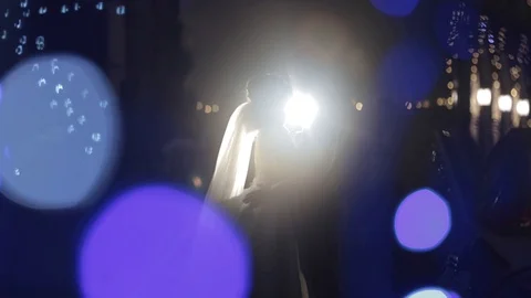 Two lovers couple hugging and kissing in the colorful UV light of a city street Video stock 128733295