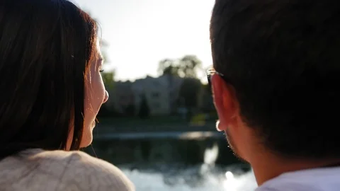 Two lovers exchanging caresses, tenderness and cuddles. Back view of happy Stock Footage 116694359