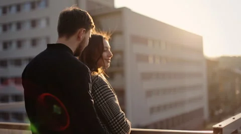 Two lovers feeling completely happy and hugging each other on the balcony Stock Footage 61843886