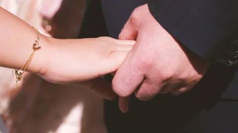 Two lovers hold hands making a gesture of affection Stock Footage 131873613