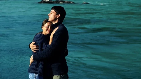 Two lovers hugging on the background of blue water 스톡 동영상 97405795