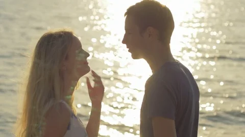 Two lovers interacting and looking at each other against the sea Video stock 73780549