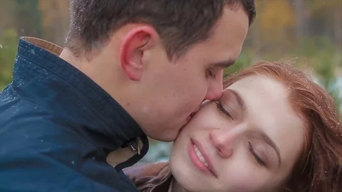 Two Lovers Kissing During Snowfall Near Pine Stock Footage 71617206