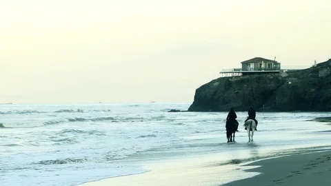 Two lovers riding on the beach Stockbeeldmateriaal 85298463