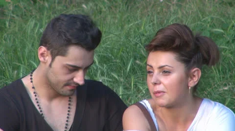 Two lovers sitting on the grass, talking. laughing 스톡 동영상 25504902