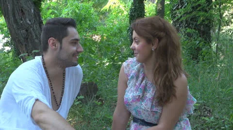 Two lovers sitting on the grass, talking. laughing 스톡 동영상 25540950