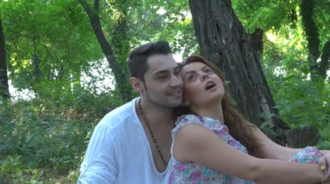 Two lovers sitting on the grass, talking. laughing 스톡 동영상 25540984