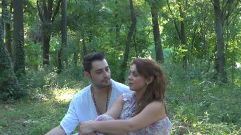 Two lovers sitting on the grass, talking. laughing 스톡 동영상 25541846