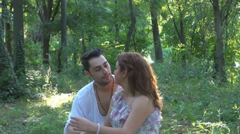 Two lovers sitting on the grass, talking. laughing 스톡 동영상 25541849