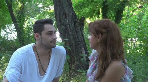 Two lovers sitting on the grass, talking. laughing 스톡 동영상 25543426