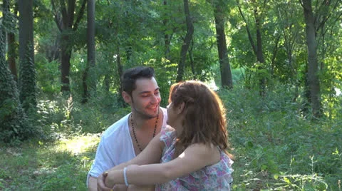 Two lovers sitting on the grass, talking. laughing 스톡 동영상 25543697