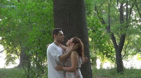 Two lovers sitting on the grass, talking. laughing 스톡 동영상 25543725