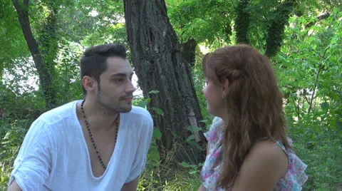 Two lovers sitting on the grass, talking. laughing 스톡 동영상 25543793