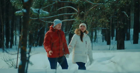 Two lovers walking in beautiful pine forest in winter, enjoy beauty of nature Stock Footage 234440150