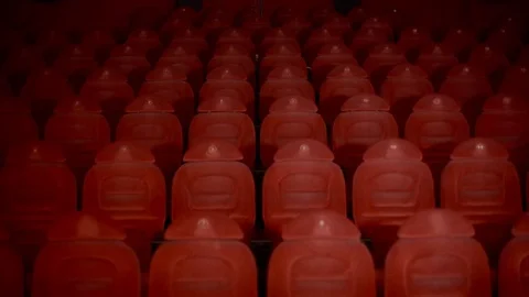 Two loving in the great, empty hall of the cinema with red chairs Stock Footage 75040144