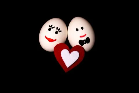 Two loving smiling eggs n black background. Stock Photos