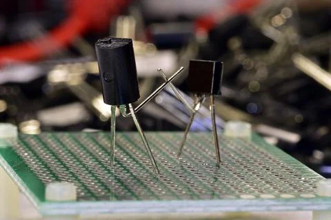 Two low-power silicon transistors in a plastic case do boxing or fencing on a Stock Photos