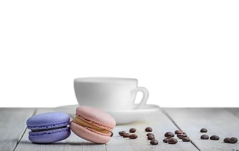 Two macaroons with cup and coffee grains Stock Photos