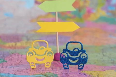 Two machine figures on the background of road signs and a map. Road travel co Stock Photos