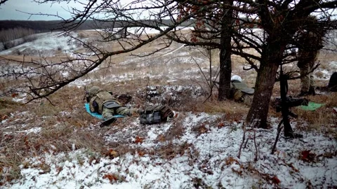 Two machine gunners fire their machine guns on a military field Видео 288826337