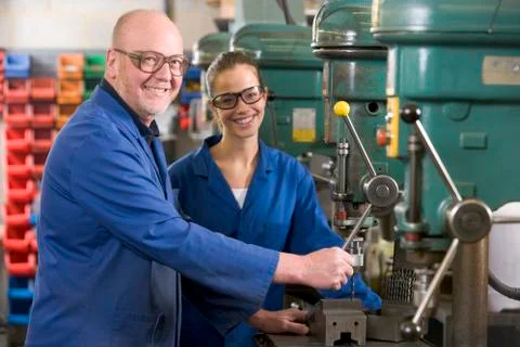 Two machinists working on machine Stock Photos