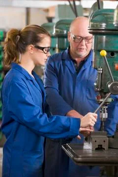 Two machinists working on machine Stock Photos