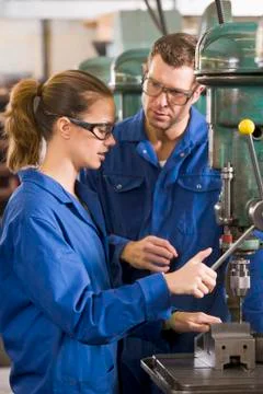 Two machinists working on machine Stock Photos