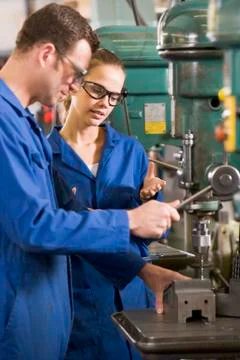 Two machinists working on machine Stock Photos