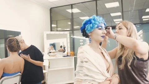 Two make-up artists make make-up models. Preparation for an artistic photo shoot Video stock 84989298
