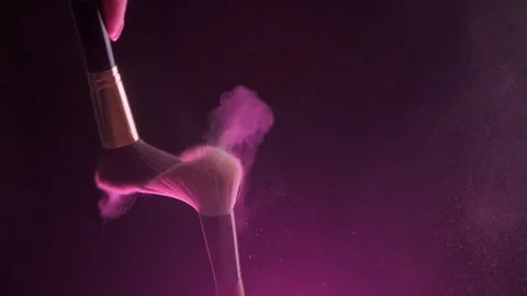 Two Make-up brushes close-up with pink powder on a black background, Slow motion Video stock 194395538