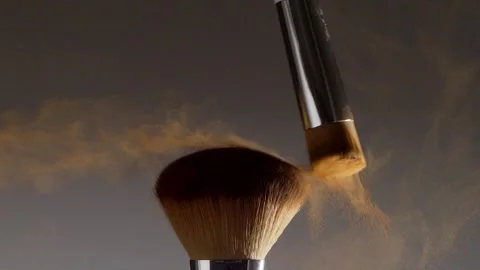 Two make-up brushes  creating an explosion of colored powder. Stock Footage 259040956