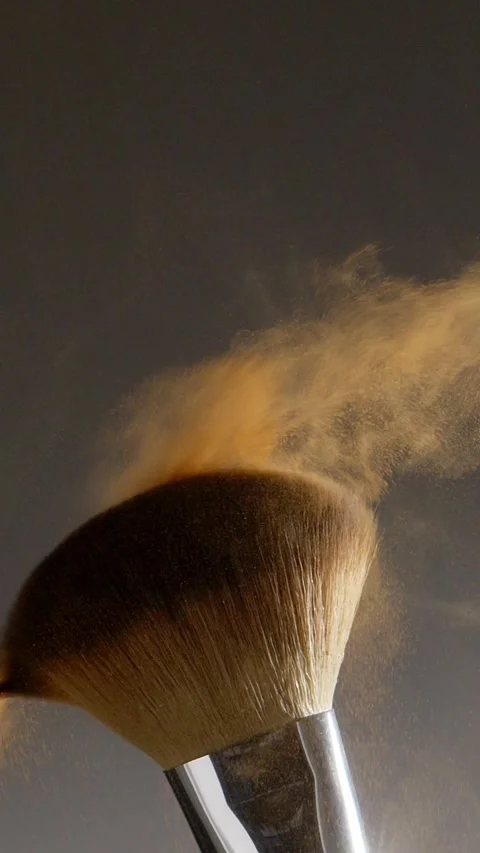 Two make-up brushes  creating an explosion of colored powder. Stock Footage 259040977