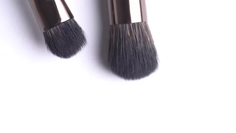 Two makeup brush rotates on a white background. Close up of several makeup .. Stock Footage 274069782