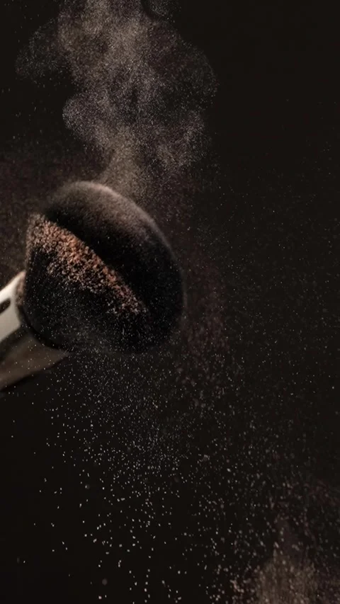 Two makeup brushes collide in slow motion, releasing a cloud of powder, blu.. Stock Footage 312762379