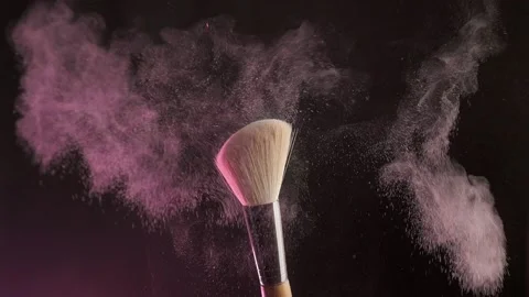 Two makeup brushes with with decorative cosmetics on a dark background, Slow Video stock 194395348