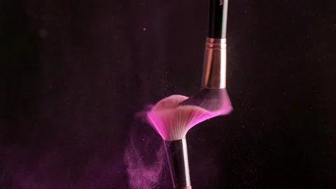 Two makeup brushes with powder on a dark background, Slow motion Video stock 194395437
