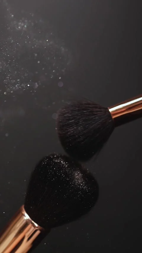 Two makeup brushes touching each other form a explode. Stock Footage 267583931