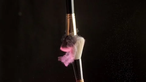 Two makeup close-up brushes on pink powder black background. Slow motion Stock Footage 194395383