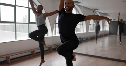 Two male ballet dancers practicing dance routine together in studio Stock Footage 147360548