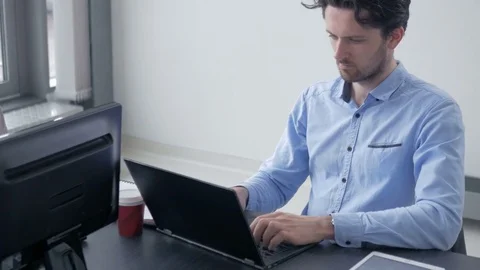 Two male colleagues working on computers in bright new office. Stock-Footage 82228878