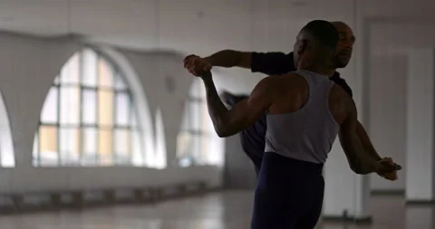 Two male dancers performing ballet together in dance studio Stock Footage 147359265