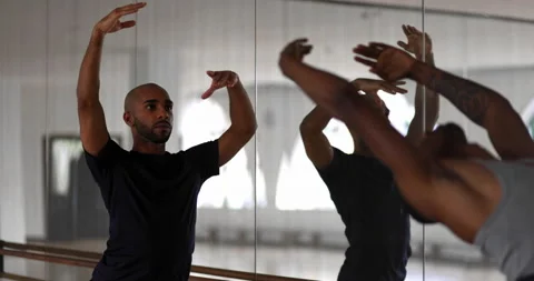 Two male dancers practicing ballet on barre in dance studio Stock Footage 147358357
