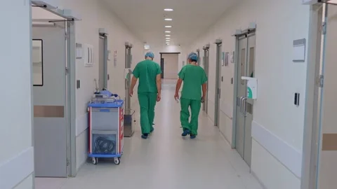 Two male doctors walking down the corridor Stock Footage 173418792
