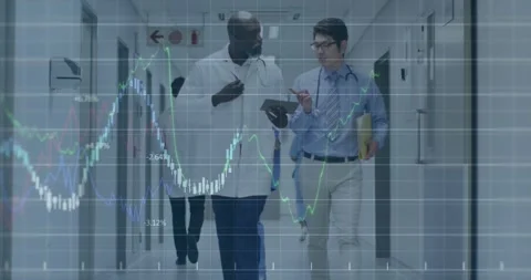 Two male doctors walking ward hall consulting and tapping tablet revealing Stock Footage 333967460