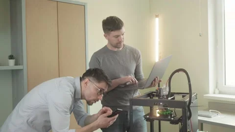 Two male electronic engineer are using computer laptop checking work of advanced Stock Footage 236298996