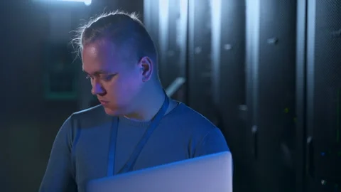 Two male engineers working with laptop, tablet and inspecting hardware in big Stock Footage 165196440