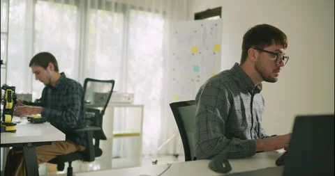 Two Male Engineers Working on Robotics Code and Hardware. Stock Footage 306737479